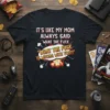 Black t-shirt with white and yellow text: "IT'S LIKE MY MOM ALWAYS SAID 'WHAT THE FUCK' 'WHAT THE FUCK IS