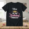 Mom Of The Birthday Princess text with a golden crown and pink hearts graphic on a black t-shirt