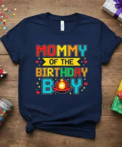 Mommy Of The Birthday Boy text with pixelated design and firefighter helmet graphic on a navy blue t-shirt