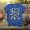 Most Definitely Not All In A Row quote with cute yellow ducks in various poses on a royal blue t-shirt