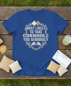 Blue t-shirt with "Most Likely To Take Cornhole Too Seriously" text, cornhole bags, and fists graphic
