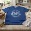 Blue t-shirt with "most loved GRANDMA" text in a floral wreath design, suitable for grandmothers