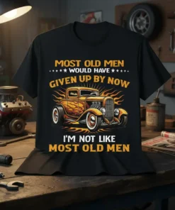 Black t-shirt with yellow text "Most Old Men Would Have Given Up By Now I'm Not Like Most Old Men"
