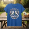 Mother of Pomeranian text with two fluffy Pomeranian dogs and floral border on a blue t-shirt