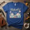 Motherhood is my MINISTRY t-shirt design with floral accents and butterflies, featuring elegant gold and pastel typography