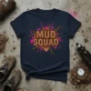 Mud Squad t-shirt design with glitter text and pink and brown mud splatters, featuring a small heart graphic