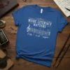 Blue t-shirt with white and gold text "MUSIC LITERACY MATTERS I like to eat puppies" over musical notes