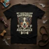 My Australian Shepherd Is An Ausshole funny dog t-shirt with a shield graphic of an Australian Shepherd dog face