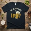 My Blood Type is IPA+ text with a glass of IPA beer and hops graphic on a navy t-shirt
