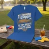 Blue t-shirt with "MY CORNHOLE TECHNIQUE IS TOP SECRET EVEN I DON'T KNOW WHAT I'M DOING" text and a cornhole