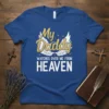 My Daddy watches over me from HEAVEN text with angel wings graphic on a blue t-shirt