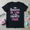 My Daughter In-Law is My Favorite Child text design in pink and white floral font on a black t-shirt