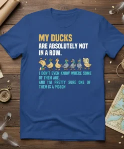 My Ducks Are Absolutely Not In A Row quote on a blue t-shirt with cartoon ducks and one pigeon