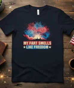 Navy blue t-shirt with "My Fart Smells Like Freedom" text in red and white, set against a backdrop of colorful