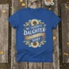 Text "My Favorite Daughter Gave Me This Shirt" with sunflower and oak leaf border on a royal blue t-shirt