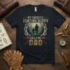 My Favorite Hunting Buddy Calls Me Dad t-shirt with silhouette of father and son hunting in forest scene surrounded by