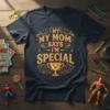 My Mom Says I'm Special text with a happy trophy graphic on a dark blue t-shirt for kids
