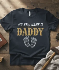 My New Name Is Daddy text with decorative font and baby feet graphic on a dark t-shirt