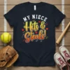 Navy t-shirt with "MY NIECE Hits & Steals!" in bold yellow and orange gradient font, accented with red hearts and