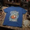 Blue t-shirt with the text "My Only Effective Attack Is Panic" and a graphic of Magikarp, featuring a distressed, retro