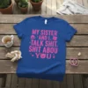 Royal blue t-shirt with bright pink text saying "MY SISTER AND I * TALK SHIT * SHIT ABOU * YOU*"
