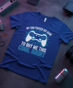 Blue t-shirt with white and light blue text: "MY SON PAUSED HIS GAME TO BUY ME THIS COOL SHIRT" and