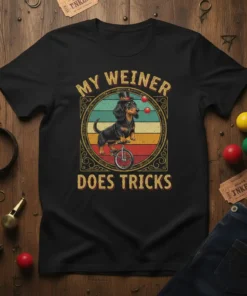My Weiner Does Tricks t-shirt featuring a dachshund wearing a top hat riding a unicycle and juggling balls, with a