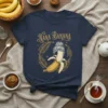 Nana Banana text with a peeled banana wearing a bun hairstyle, surrounded by golden leaves on a navy t-shirt