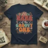 Nana of the Groovy One retro t-shirt design with bold, colorful typography and floral accents