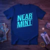 Blue t-shirt with "NEAR MINT" in distressed cyan block letters inside a rectangle, for comic collectors