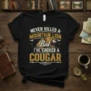 Never Killed a Mountain Lion But I've Choked a Cougar quote t-shirt with a fierce cougar graphic