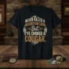 Never Killed A Mountain Lion But I've Choked A Cougar text design with mountain graphic on black t-shirt