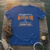 Never Mess With A Kayaker quote with graphic of kayaker in boat, on blue t-shirt
