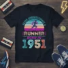 Never Underestimate A Runner Born In 1951 graphic tee with vintage sunset and running silhouette