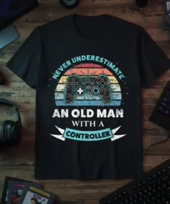 Never Underestimate An Old Man With A Controller T-Shirt featuring a vintage video game controller graphic and retro sunset design