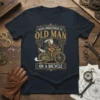 T-shirt with "Never Underestimate An Old Man On A Bicycle" text and vintage illustration of an old man riding a