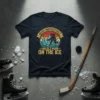 Never Underestimate An Old Man On The Ice quote on a navy t-shirt with a vintage hockey graphic
