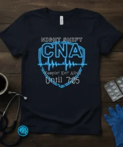 Navy t-shirt with "NIGHT SHIFT CNA Keepin' Em' Alive Until 7:05" in neon blue text and a heartbeat line graphic
