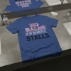 No Balls In Women's Stalls text design on a blue t-shirt with feminist symbols and bold typography