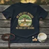 T-shirt with "No Dog Left Behind" text, featuring a scenic circular design with a large tree and four dogs standing