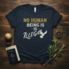 Navy t-shirt with "NO HUMAN BEING IS ILLEGAL" text in yellow and white, featuring a white dove graphic, representing peace
