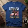 No Matter Who's President Jesus Is King text on a blue t-shirt with an American flag and a wooden cross