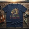 T-shirt featuring the text "NO ONE IS ILIEGAL ON STOLEN LAND" with a profile of a Native American chief in