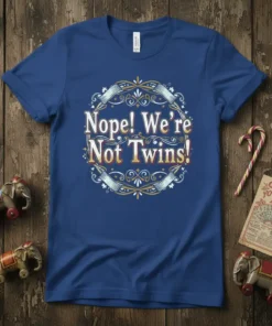 Nope! We're Not Twins! text design in a decorative circular frame on a blue t-shirt