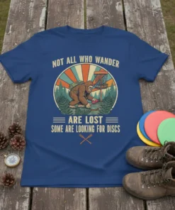 T-shirt with text "Not All Who Wander Are Lost Some Are Looking For Discs" featuring a Bigfoot playing disc golf