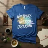 Not Crazy Not Rich Just Asian quote on a blue t-shirt with colorful paint splatter graphic