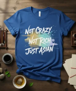 Not Crazy Not Rich Just Asian quote on a blue t-shirt with colorful paint splatter graphic