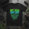 Black t-shirt with neon green and cyan 'NOT DEAD CANT QUIT' text over a stylized skull graphic