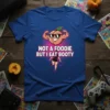 Not A Foodie But I Eat Booty t-shirt with a muscular peach character and running woman graphic