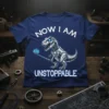 Now I Am Unstoppable Robot T-Rex T-Shirt with cybernetic dinosaur taking a selfie. White text and blue glowing eyes